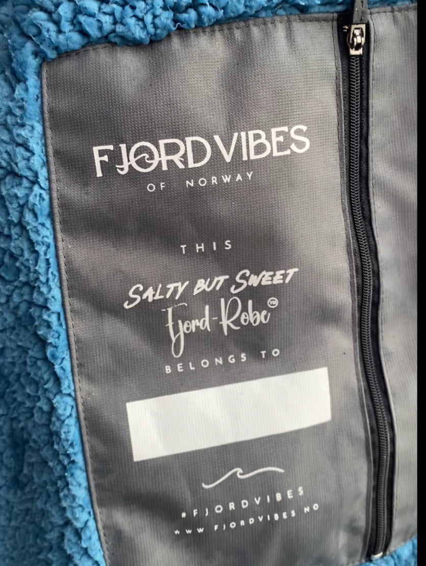 bilde av en innerlomme på badekåpen til FjordVibes of Norway ed blå teddy- fleece inni kåpen